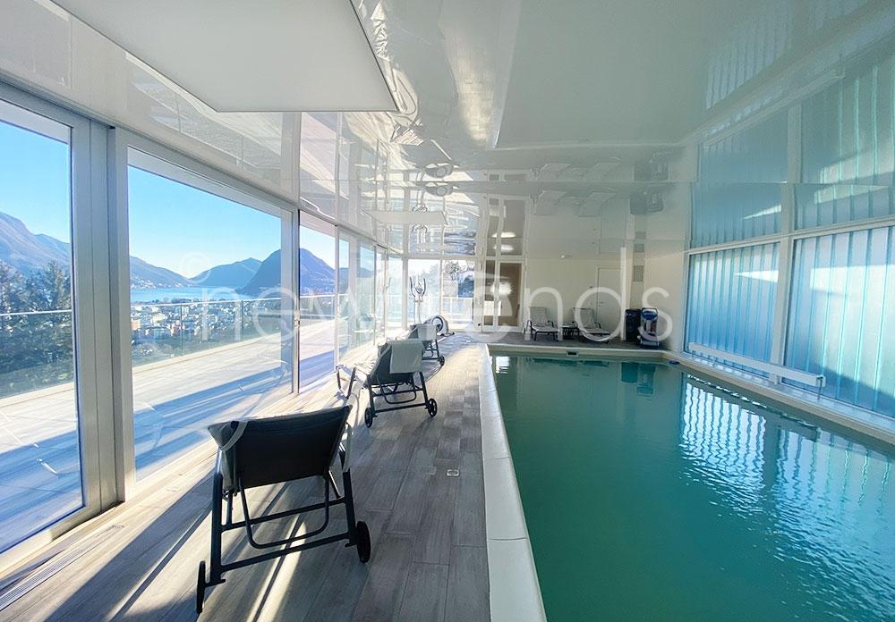affitto comodo appartamento con ampia terrazza vista lago, piscina, solarium, area wellness e fitness a porza: foto piscina